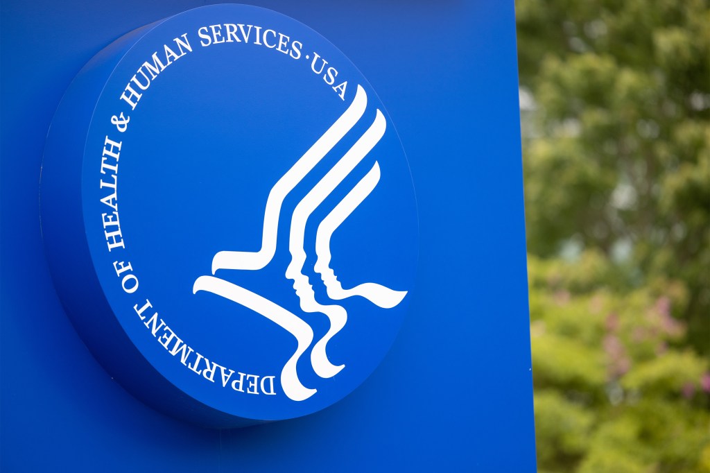 A photo of a large blue sign with the logo of the Department of Health and Human Services.