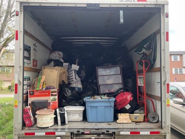 A photo of a box truck's cargo area filled with boxes and other items.