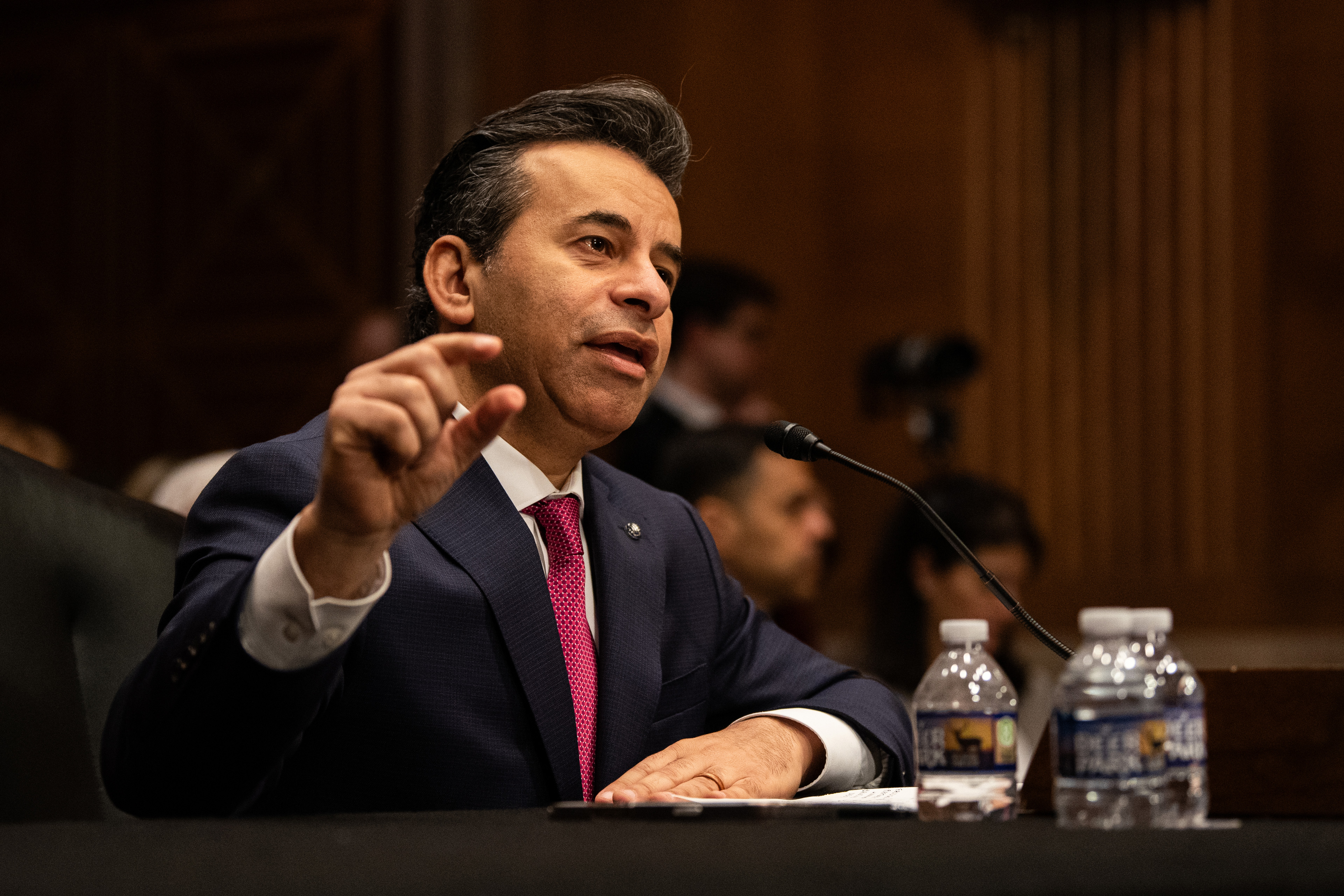 A photo of Martin Makary speaking during a Senate HELP Committee hearing concerning his nomination to lead FDA. He is gesturing with his right hand.