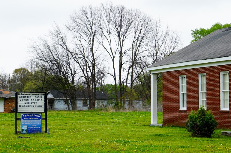 The exterior of a red-brick church.