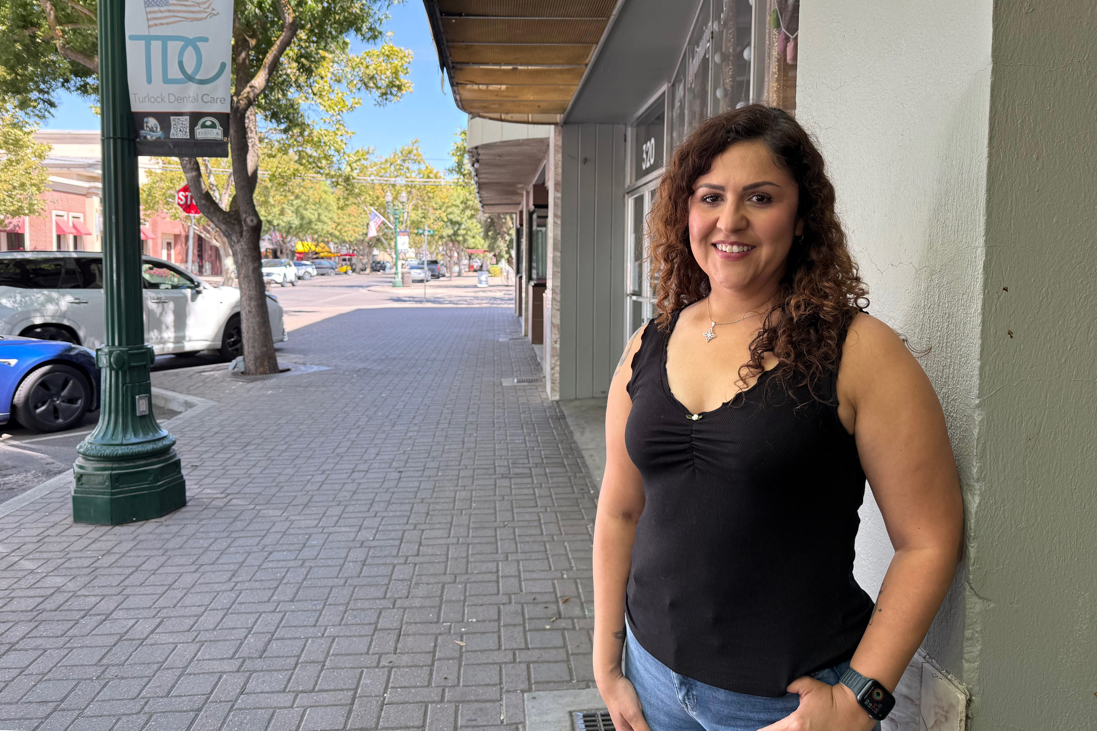 A photo of a woman standing outside.