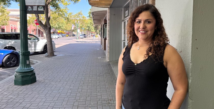 A photo of a woman standing outside.