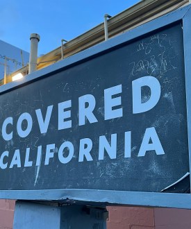 A photo of a sign advertising Covered California, the state's Affordable Care Act marketplace, in Los Angeles.